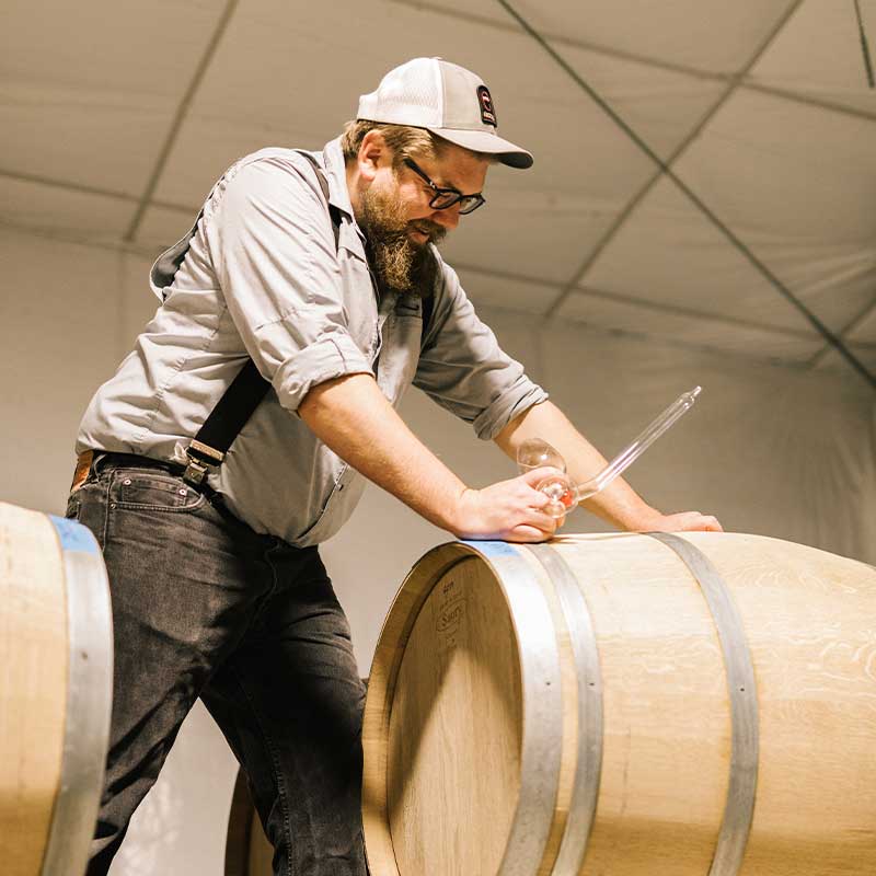 Edward Darren sampling a barrel at Rincon Mountain Winery